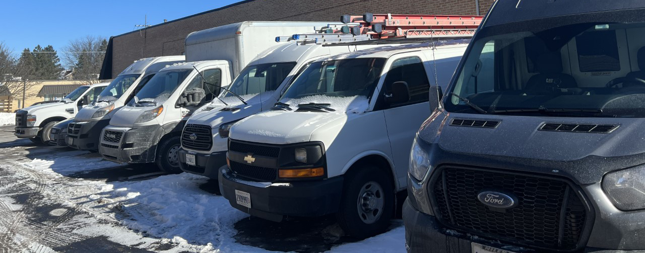 cars, buses and vans used by gutter installation and replacement company